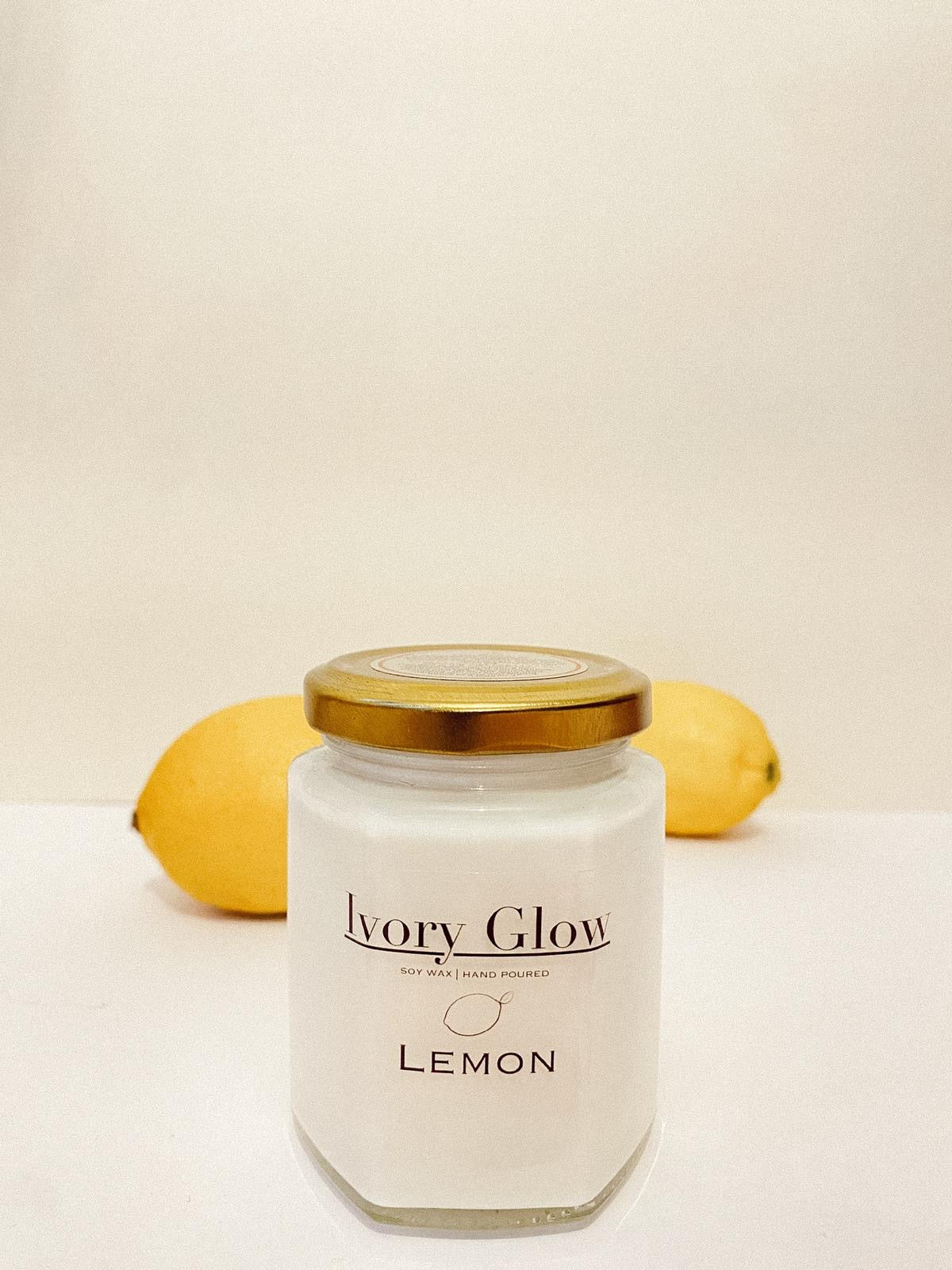 A luxury lemon candle in an elegant, minimalist glass jar, exuding a fresh, citrus aroma. The sophisticated design features a sleek label with gold accents, perfect for upscale home decor. Ideal for creating a refreshing and serene ambiance.