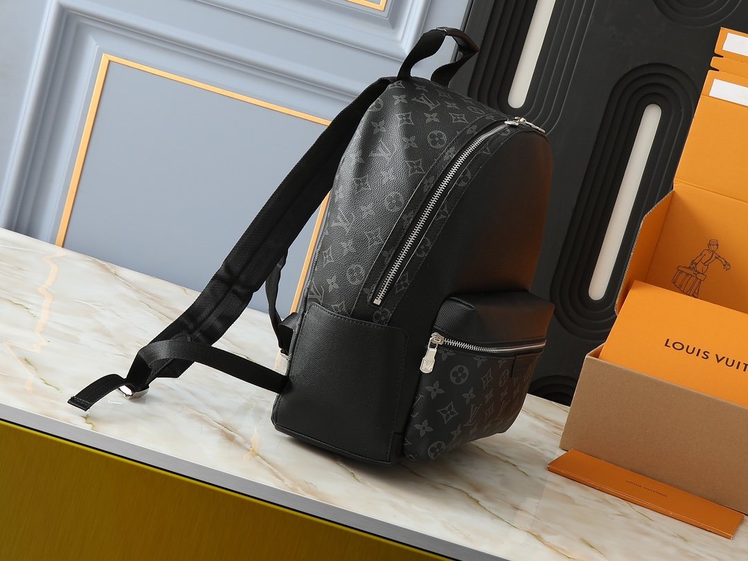 Louis Vuitton Discovery Monogram Backpack — side