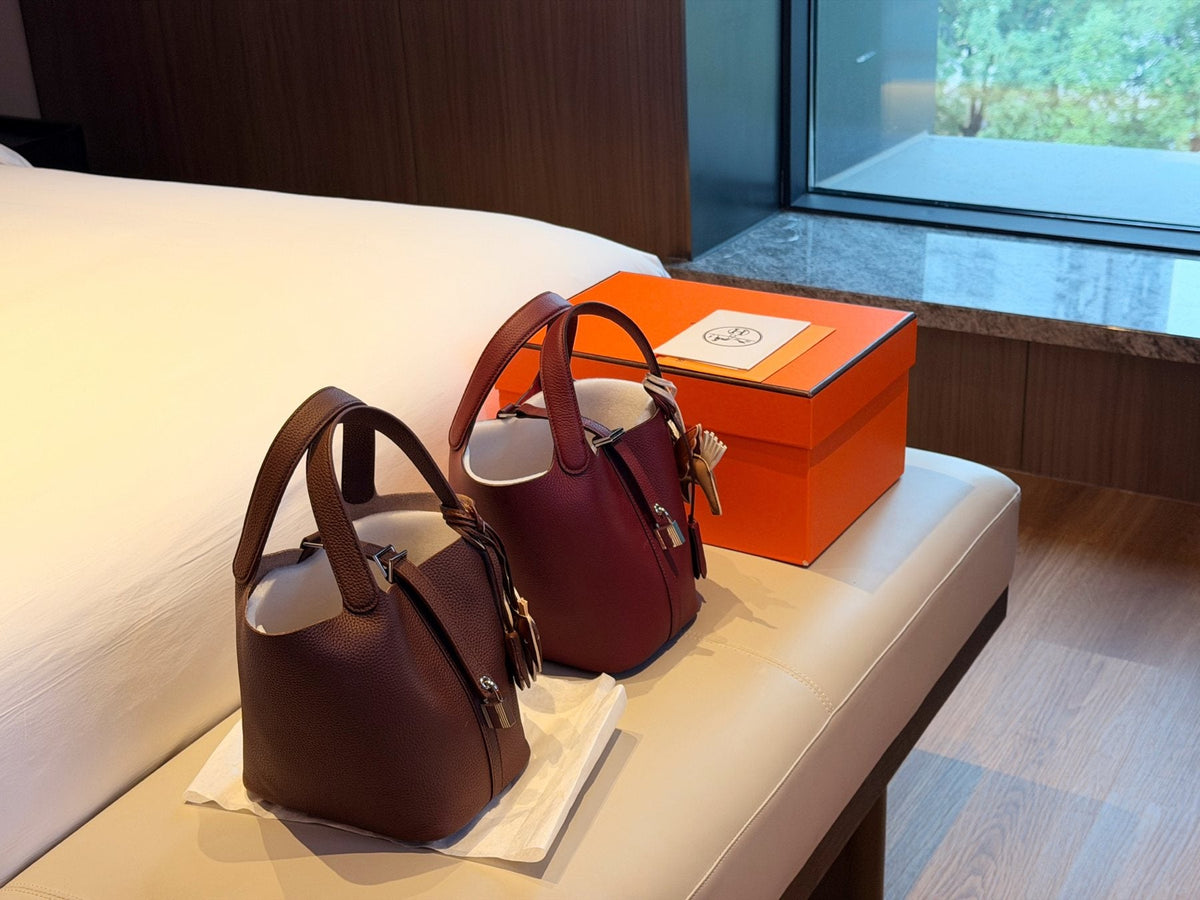 Hermès Curved-Panel Top-Handle Bucket Bag — comparison
