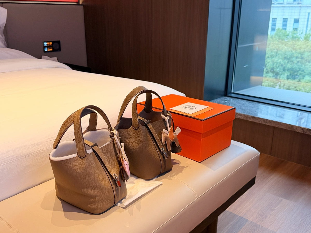 Hermès Curved-Panel Top-Handle Bucket Bag — comparison